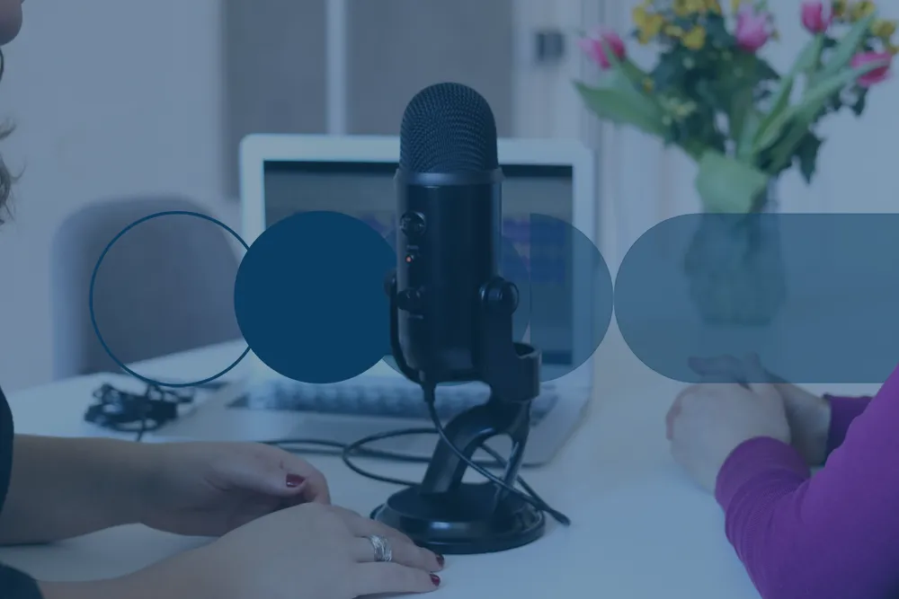 Two girls with a microphone recording a podcast